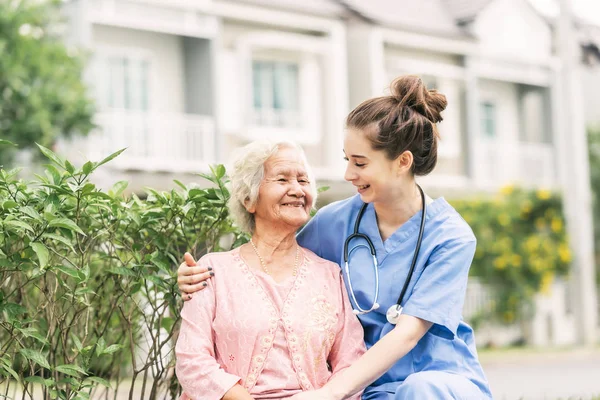 アジアの高齢女性を屋外で介護者 — ストック写真