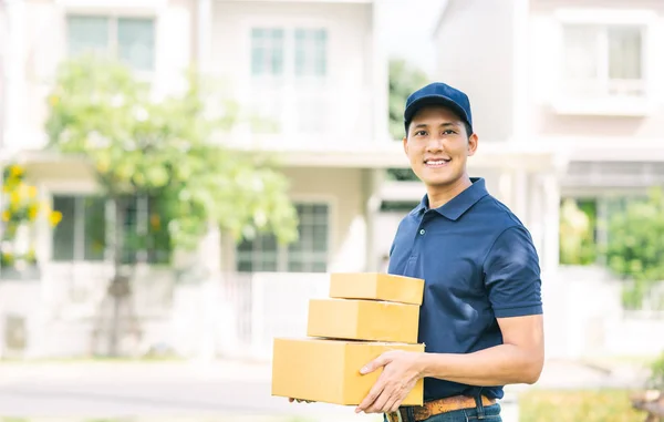 Courier making a home delivery holding stck of parcel