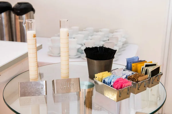 Regular and skim milk on coffee table at corporate event