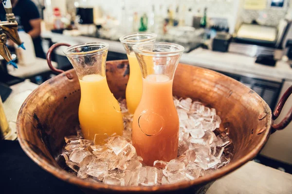 Fresh Tropical Orange Assorted Juices Glass Bottles Ice Bar Counter — Stock Photo, Image