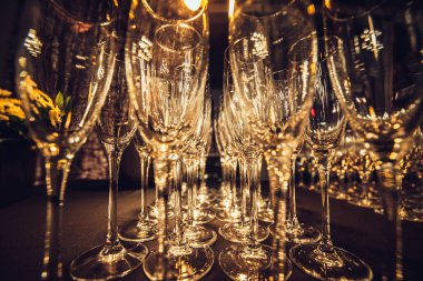 Empty champagne glasses in row on evening event party waiting for the guests   clipart