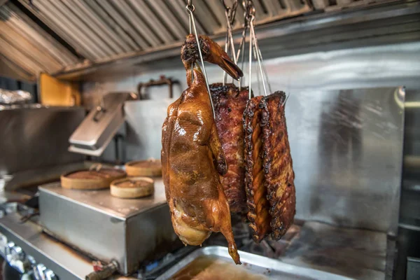 Cooked Beijing roast duck and smoked ribs on restaurant kitchen