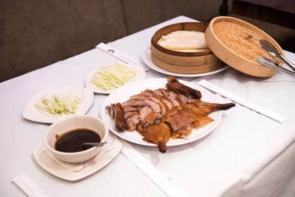 Cooked Beijing roast duck served on a plate in a restaurant