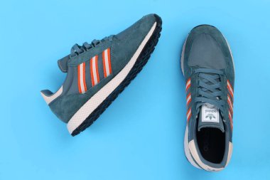 Jeddah Suudi Arabistan 25 Temmuz 2020 ADIDAS spor ayakkabısı, mavi arka planda. Ürün çekimi. Adidas spor ayakkabıları, giysileri ve aksesuarları tasarlayan ve üreten bir Alman şirketidir.