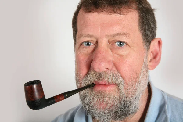 Mature scandinavian man smoking  pipe