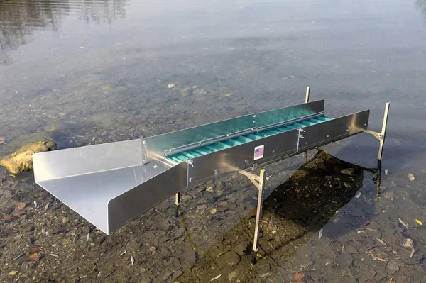 Sluice or washing ramp in situation in the water to search for gold Stock Image