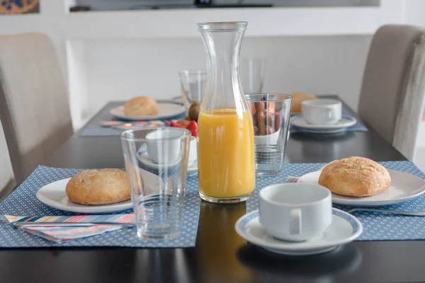 Beyaz tabakta taze kabuklu ekmek ve bir bardak meyve suyu ile tabak