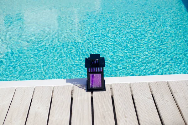 Candle lantern near the pool's edge on a summer's day, Portugal — Stock Photo, Image