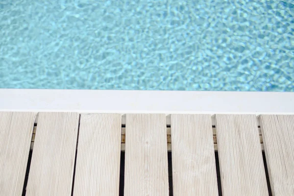 Swimming pool side with blue water background — Stock Photo, Image