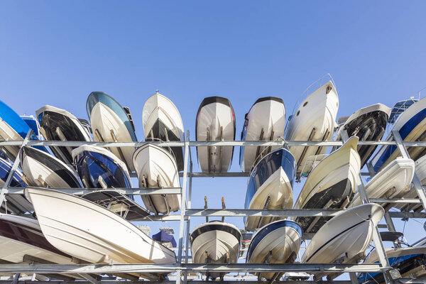 speed motor boats are stapled in a garage system in the prestigious harbor in Miami