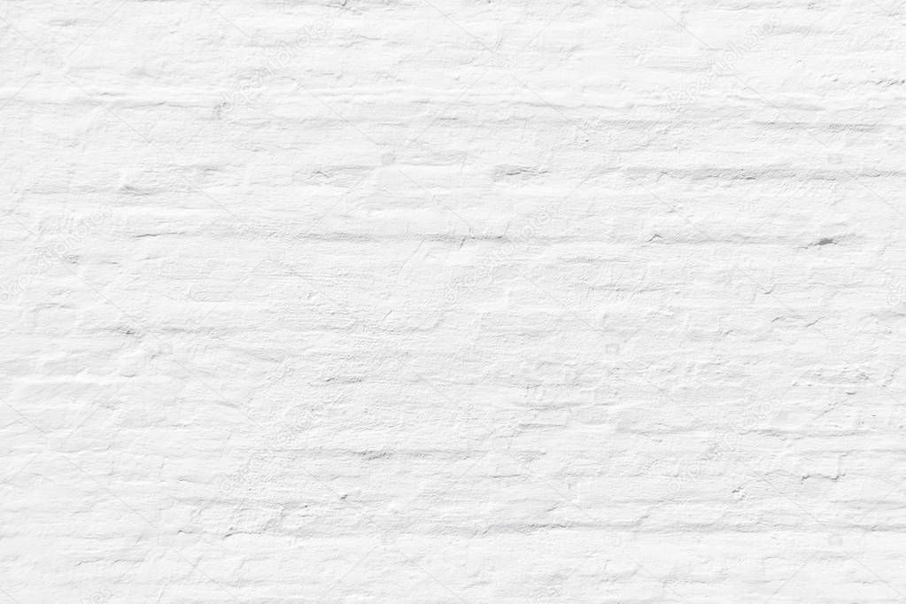 pattern of white painted brick wall gives a harmonic neutral background