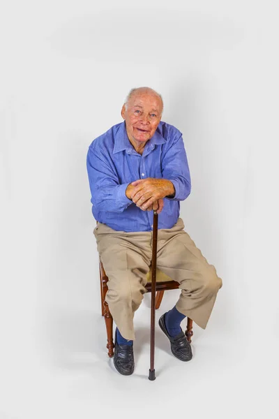 Happy Elderly Man Sitting Front White Background — Stock Photo, Image