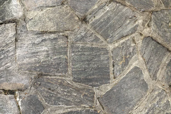 Mönster av gamla oregelbundna stenar ger en harmonisk bakgrund — Stockfoto