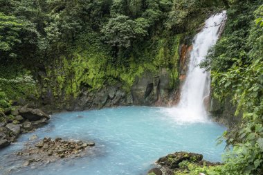 scenic waterfall in tenorio volcano national park clipart
