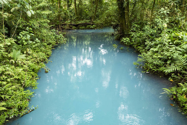 scenic Rio Celeste in the rain 