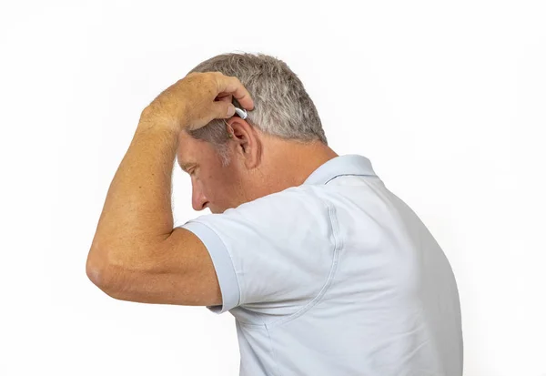 Portrait of trustful smiling mature man handling his hearing aid — Stock Photo, Image