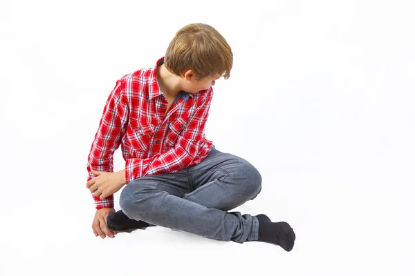 Smart boy sitting on the floor — Stock Photo, Image