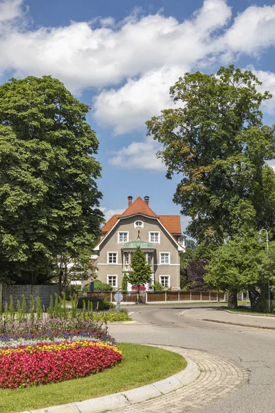 Typical historic old house with road and colotful round about in — Stock Photo, Image