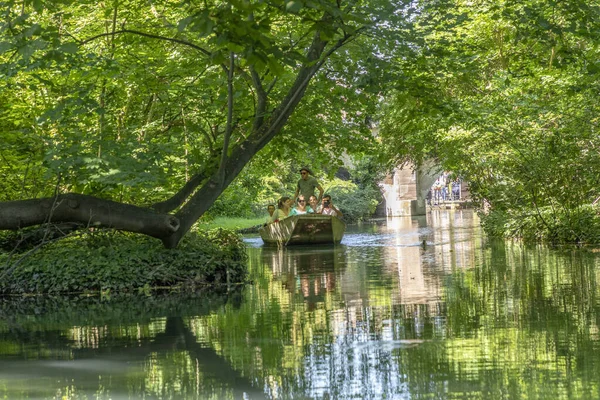 As pessoas gostam de um passeio de barco em um canal verde em Colmar — Fotografia de Stock