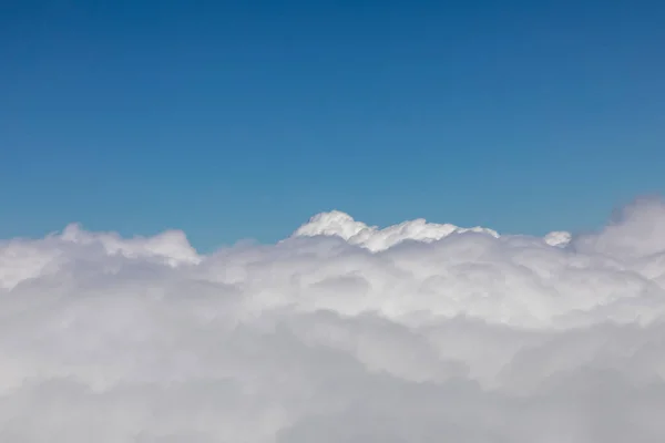 background of white puffy clouds under clear blue sky