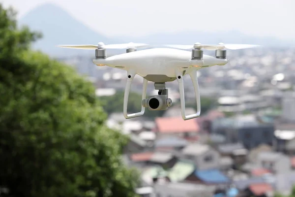 White drone flying over the city, cityscape of Kagawa, Japan