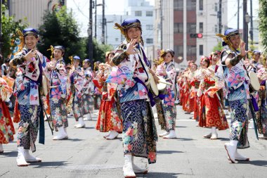KAGAWA, JAPAN - JULY 15 2018: Japanese performers dancing in the famous Yosakoi Festival, yearly free public event. Yosakoi is a unique style of Japanese dance event. clipart