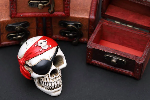 Skeleton pirate with treasure chest on dark background