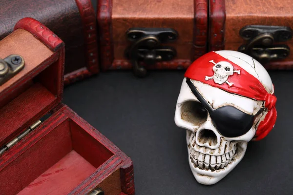 Skeleton pirate with treasure chest on dark background