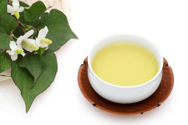 Houttuynia cordata tea, healthy dokudami drink, on white background clipart