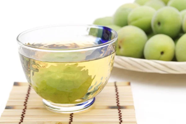 Japanese plum wine called umeshu on white background