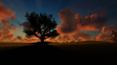 Adam bisikletin üstünde yeşil çayır timelapse gündoğumu karşı