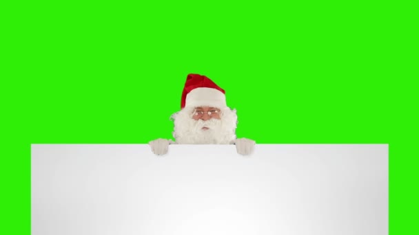 圣诞老人出现在一张空白的白纸后面 上面有绿色的屏幕 — 图库视频影像