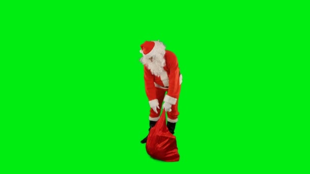 Weihnachtsmann Mit Einer Tüte Voller Geschenke Schnippt Mit Den Fingern — Stockvideo