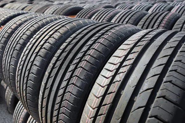 New tires for sale at a tire store. Car tires in the warehouse under the open sky