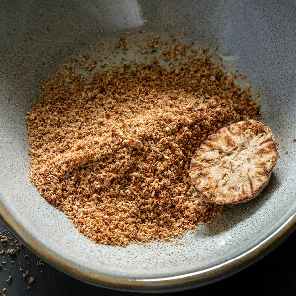 Nutmeg Whole Grated Rustic Bowl Closeup View — Stock Photo, Image