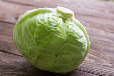 Erken lahana, ahşap arka planda beyaz lahana kafası