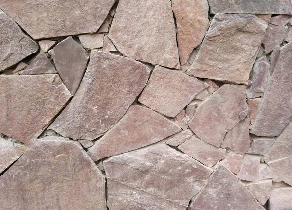 stone wall, the texture of the outer wall decorated with decorative stone of various shapes, mosaic