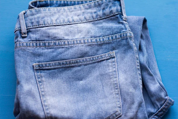 Folded Blue Jeans Blue Background — Stock Photo, Image