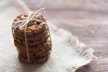 delicious crispy oatmeal cookies with chocolate chips on a napkin