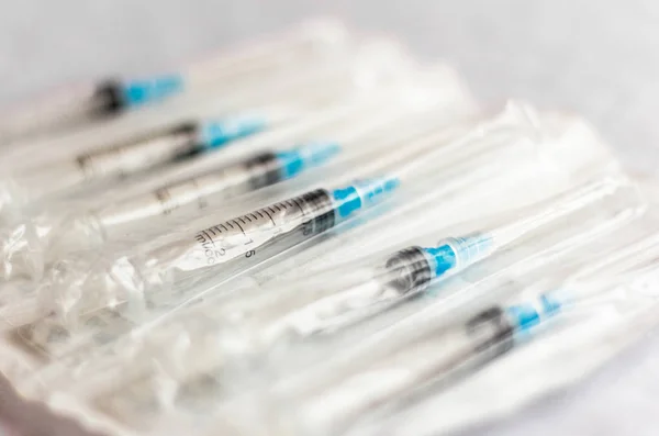new disposable injection syringes in the package, close-up, selective focus