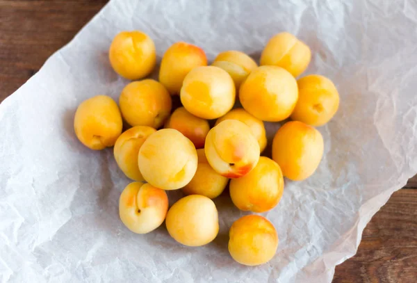 delicious ripe apricots on paper on the table