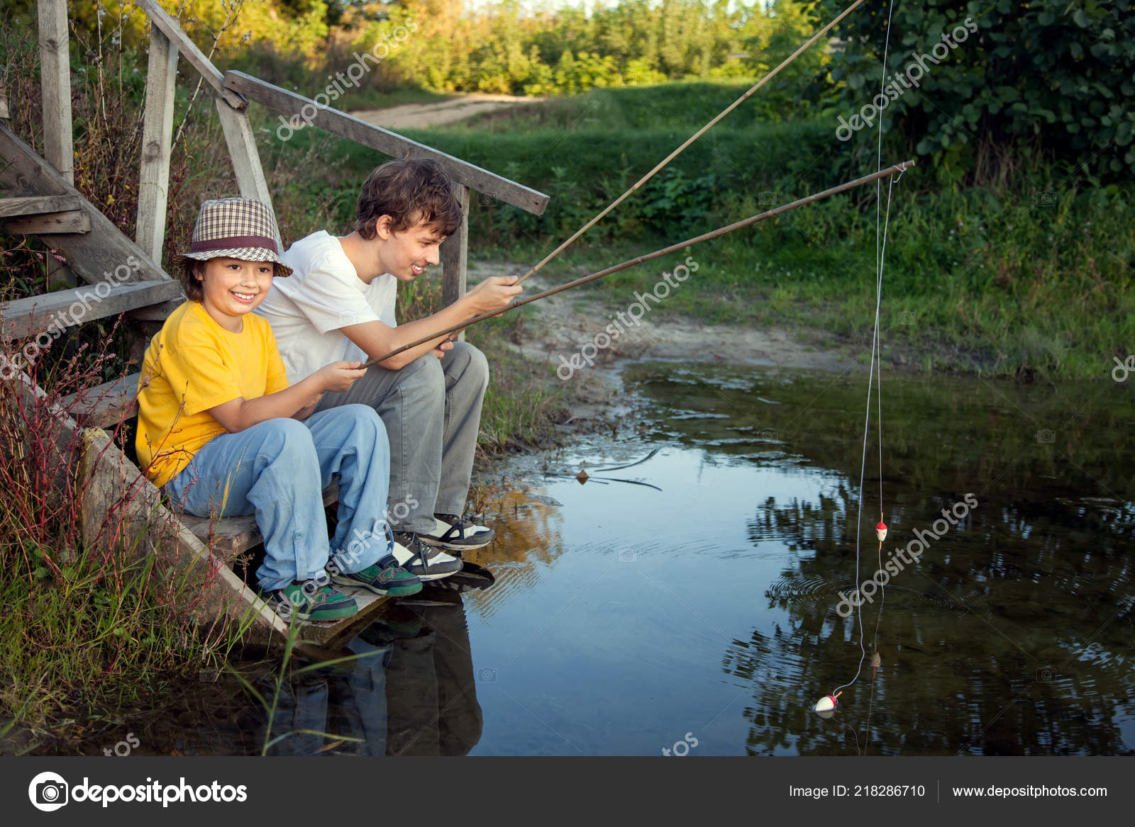 https://st4.depositphotos.com/1067336/21828/i/1600/depositphotos_218286710-stock-photo-happy-boys-fishing-river-two.jpg