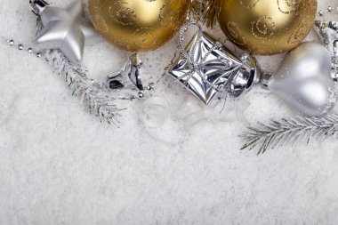 silver and golden christmas decoration in snow with copy space clipart