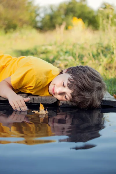 Boy Playing Autumn Leaf Ship Water — Stock Photo, Image