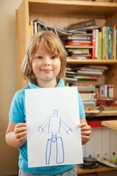 Happy boy shows his drawing at home — Stock Photo, Image