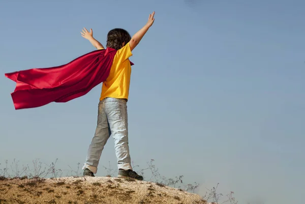 Boy playing superheroes on the sky background, teenage superhero — Stock Photo, Image