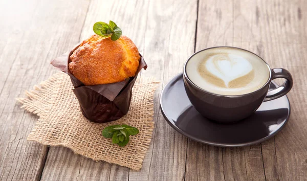 Chocolate muffins mint and coffee on wooden table — Stock Photo, Image