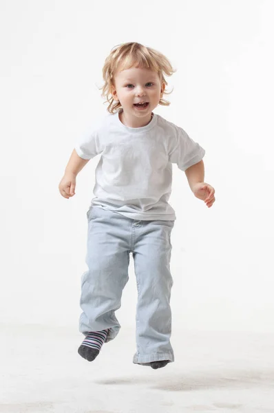 Niño Feliz Saltando Sobre Fondo Blanco Fotos De Stock