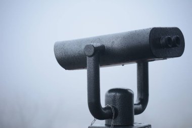 Dürbün beyaz sis bir arka plan üzerinde manzaraları gözlemlemek için.