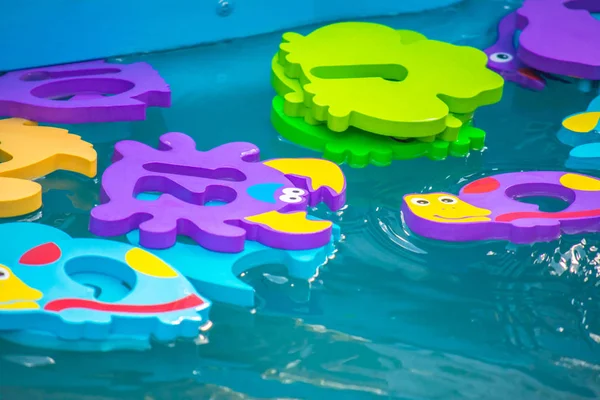 Educational water game for children. Fish in the form of letters of numbers and images of animals and a net for fishing. Fun for kids